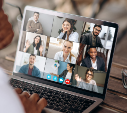 Laptop screen with nine people on a virtual meeting 