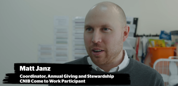 Matt Janz, Coordinator of Annual Giving and Stewardship and CNIB Come to Work participant, speaking indoors in an office setting. His name and title appear in white text on a black banner at the bottom of the image.